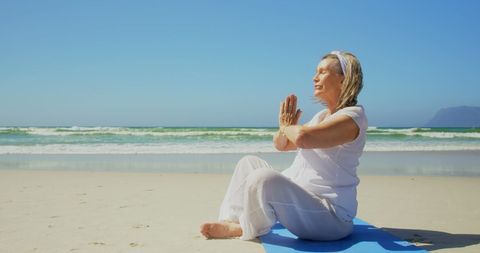 Senior Woman Meditating on Beach in Calm Yoga Pose - Download Free Stock Images Pikwizard.com