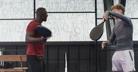 Diverse Friends Competing on Padel Court, Emphasizing Team Spirit and Urban Lifestyle