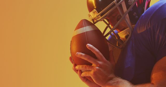 American Football Player Holding Ball Against Orange Gradient Background - Download Free Stock Images Pikwizard.com