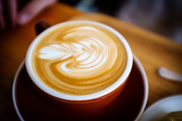 Perfect for usage in cafe or coffee shop ads, this image highlights the art of skilled baristas. It can also be used in lifestyle blogs, social media posts promoting relaxation and comfort, food and drink articles, or any content related to coffee culture.