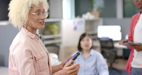 Businesswoman Leading Meeting with Colleagues in Modern Office