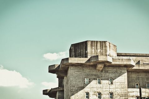 Urban Fortress Against Blue Sky with Minimal Clouds - Download Free Stock Images Pikwizard.com