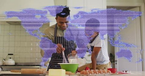 Father and son whisking in kitchen with purple world map overlay for global bonding