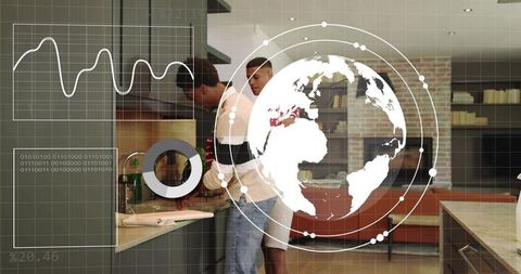 Two men washing dishes and rinsing with augmented reality globe overlay in modern kitchen