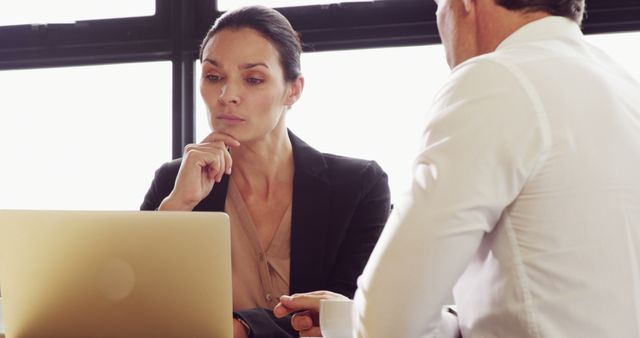 Businessman and Businesswoman Collaborating on Laptop in Office - Download Free Stock Images Pikwizard.com