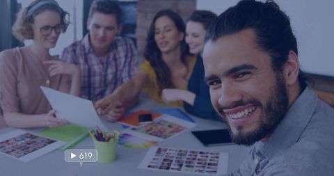 Creative team brainstorming with smiling leader guiding design meeting, teamwork focus