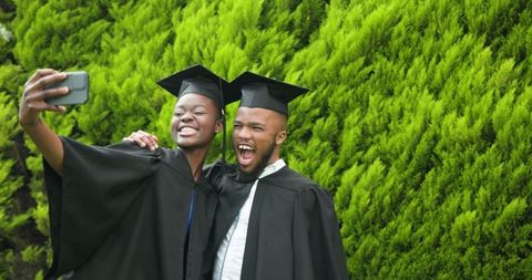 Graduating Friends Celebrating with Selfie Outdoors