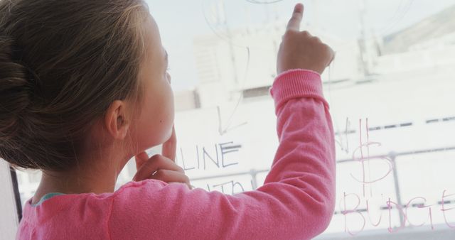 Young Girl Writing on Glass with Dry Erase Marker - Download Free Stock Images Pikwizard.com