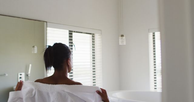 Woman Holding Towel in Modern Bathroom - Download Free Stock Images Pikwizard.com