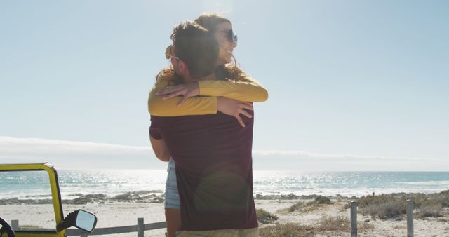 Couple embracing on coastal road trip with ocean in background. Captures summer travel, youthful adventure, and romantic moments. Ideal for travel blogs, relationship content, vacation advertising, and tourism promotions.