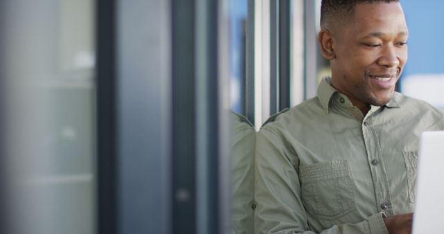 Man Using Laptop Smiling in Bright Modern Office - Download Free Stock Images Pikwizard.com