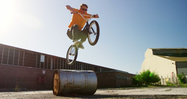 Young Man Performing BMX Trick in Industrial Area - Download Free Stock Images Pikwizard.com