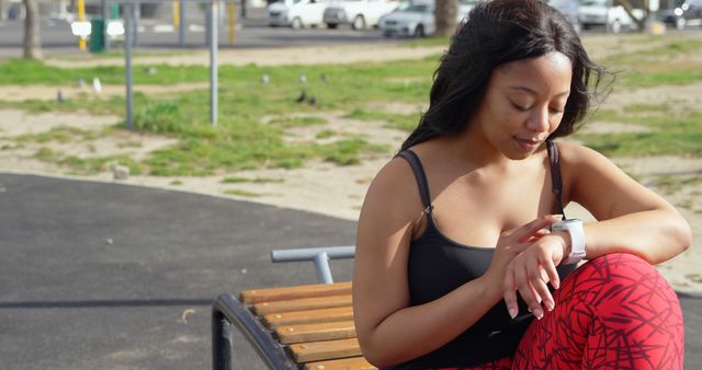 Woman Checking Smartwatch During Outdoor Workout in Park - Download Free Stock Images Pikwizard.com