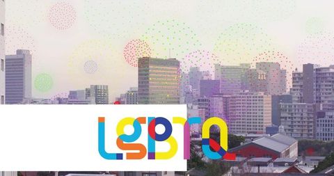 Multicolored lgbt pride banner over pastel urban skyline at dusk