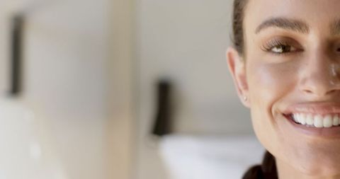 Close-Up of Smiling Woman with Long Lashes and Stud Earring
