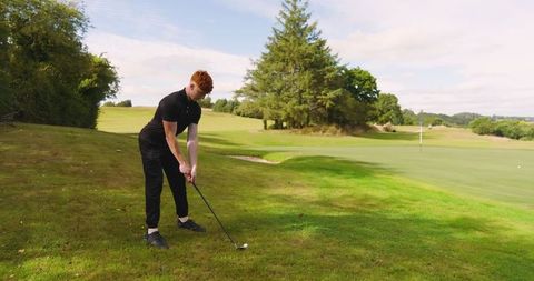 Teenage Boy Playing Golf on Scenic Fairway