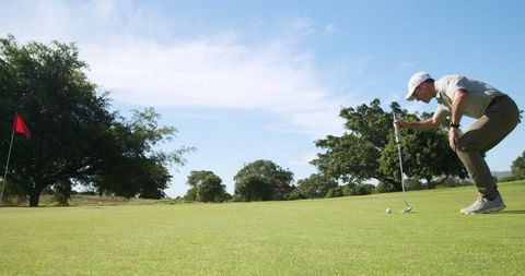 Golfer Strategically Aligning Shot for Perfect Putt - Download Free Stock Images Pikwizard.com