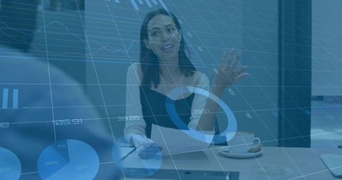 Businesswoman reviewing documents with data overlay