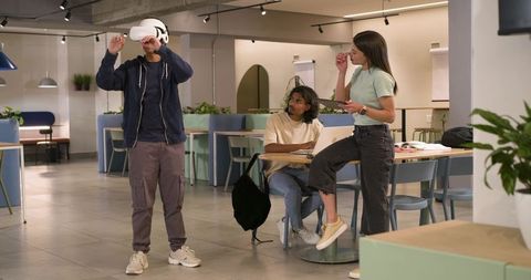 African American team testing virtual reality headset in modern coworking hub