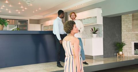 Young couple touring modern home with estate agent discussing residence