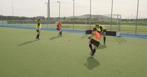 Dynamic field hockey practice outdoors with female team