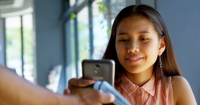 Young Woman Making Contactless Payment with Smartphone - Download Free Stock Images Pikwizard.com