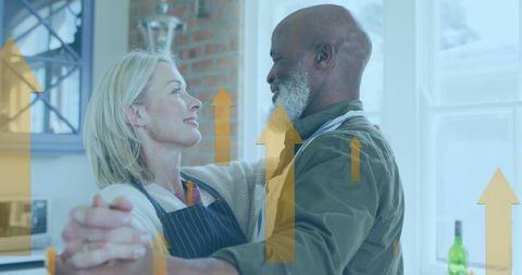 Diverse Senior Couple Dancing Comfortably in Kitchen