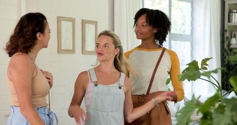 Diverse Female Friends Socializing in Bright Living Room