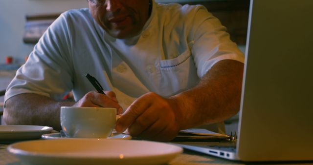 Chef Writing Notes with Coffee Cup and Laptop - Download Free Stock Images Pikwizard.com