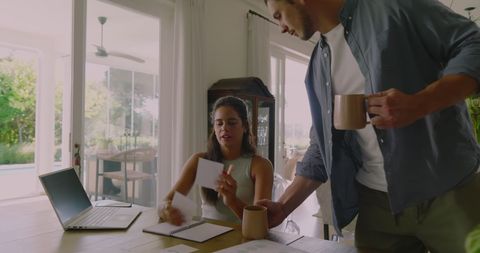 Couple planning wedding together at table with coffee