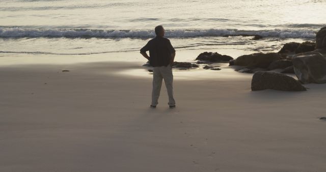 Man Standing on Beach during Sunset Contemplating Ocean - Download Free Stock Images Pikwizard.com