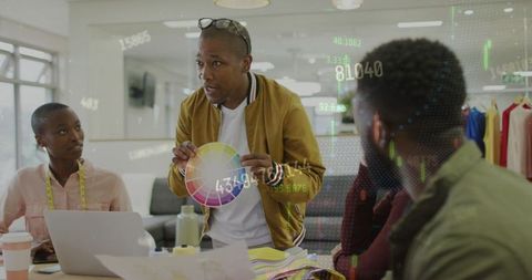 Diverse designers analyzing color palette in creative office setting