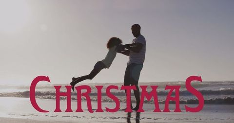 Joyful Father and Daughter Playing on Beach During Sunset