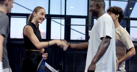 Diverse Padel Athletes Shaking Hands on Court after Match