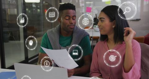 Diverse business team analyzing virtual data in modern office