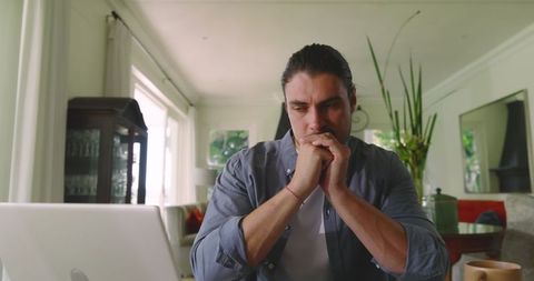 Focused Freelancer Writing Notes in Home Office Environment