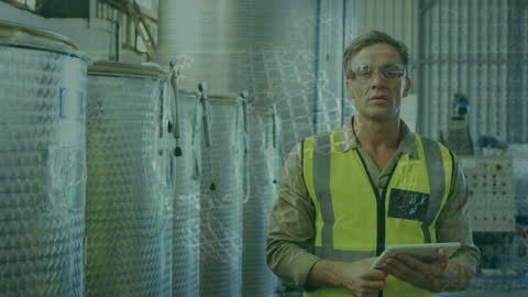 Industrial Worker Analyzing Data on Digital Tablet in Factory