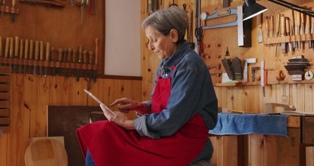 Senior Female Woodworker Using Digital Tablet in Workshop - Download Free Stock Images Pikwizard.com