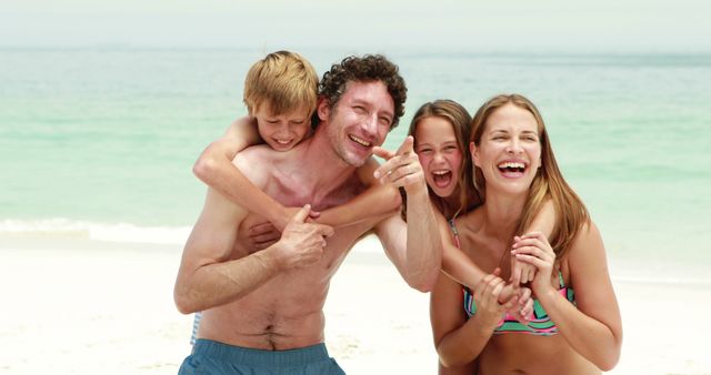 Perfect for advertisements about family vacations, travel brochures promoting beach destinations, lifestyle blogs focused on family bonding, and summer-themed marketing materials. Ideal for conveying happiness, relaxation, and familial love.