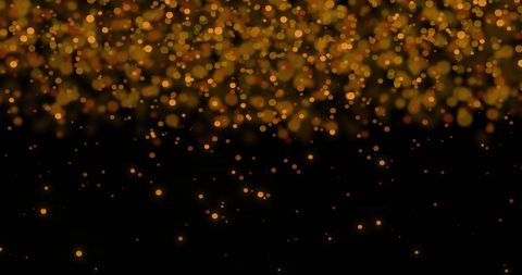 Floating Gold Light Particles on Black Background