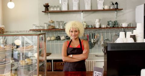 Spirited Barista Welcoming Customers in Cozy Coffee Shop Setting