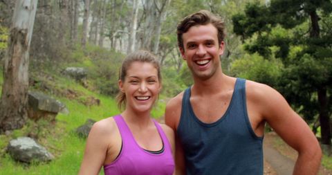 Happy couple enjoying outdoor exercise on nature trail