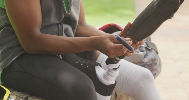 Person Adjusting Prosthetic Leg in Outdoor Setting - Download Free Stock Images Pikwizard.com