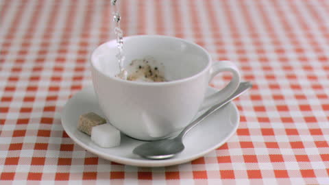 Slow Motion Instant Coffee Preparation on Checkered Table