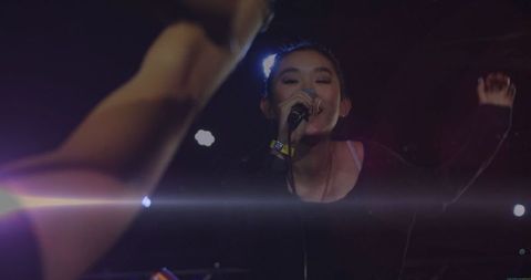 Energetic vocal performance by female singer on stage