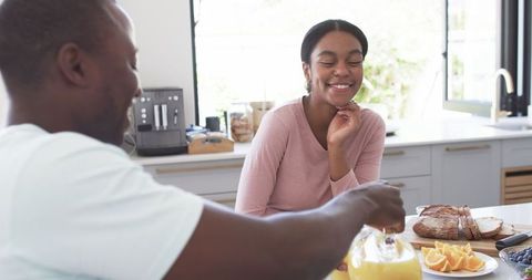 Couple Enjoying Morning Breakfast with Fresh Orange Juice