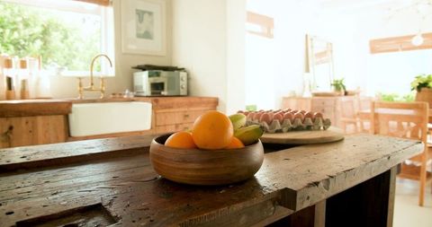 Rustic kitchen with fresh fruit bowl on wooden countertop