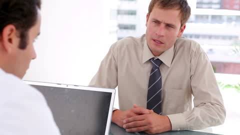 Businessman Consulting Doctor in Modern Office Setting