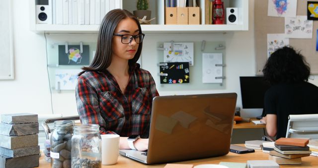 Young Woman Working on Laptop in Modern Office Environment - Download Free Stock Images Pikwizard.com