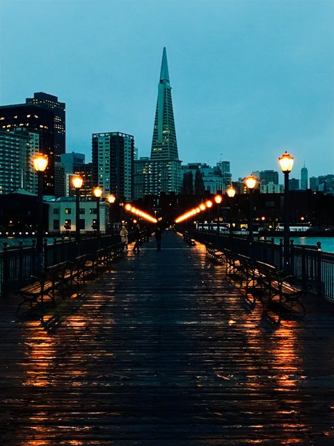 Evening Cityscape with Illuminated Lamps on Pier - Download Free Stock Images Pikwizard.com